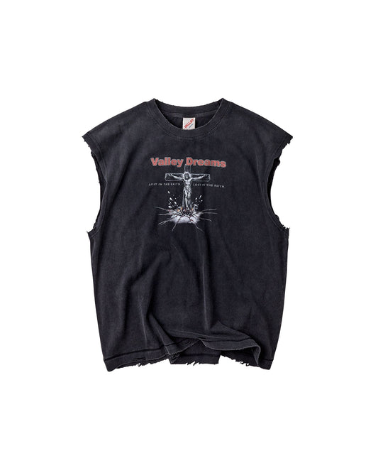 A black acid-washed sleeveless crop top with distressed frayed edges, featuring a white graphic of a crucifix and the text 'Valley Dreams' in red and white on the chest.