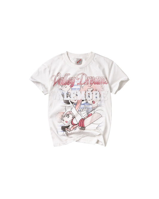 A white short-sleeve graphic t-shirt featuring a manga-style illustration of Sailor Moon and the text 'Valley Dreamers' in pink script across the chest.